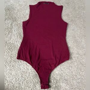 Red sleeveless one piece.